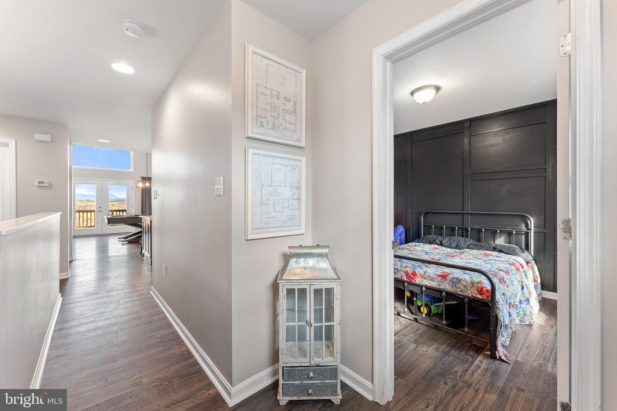 11652 Alum Springs Road Rixeyville, VA 22737 - Photo 21 of 64 a bedroom with a bed and a chandelier