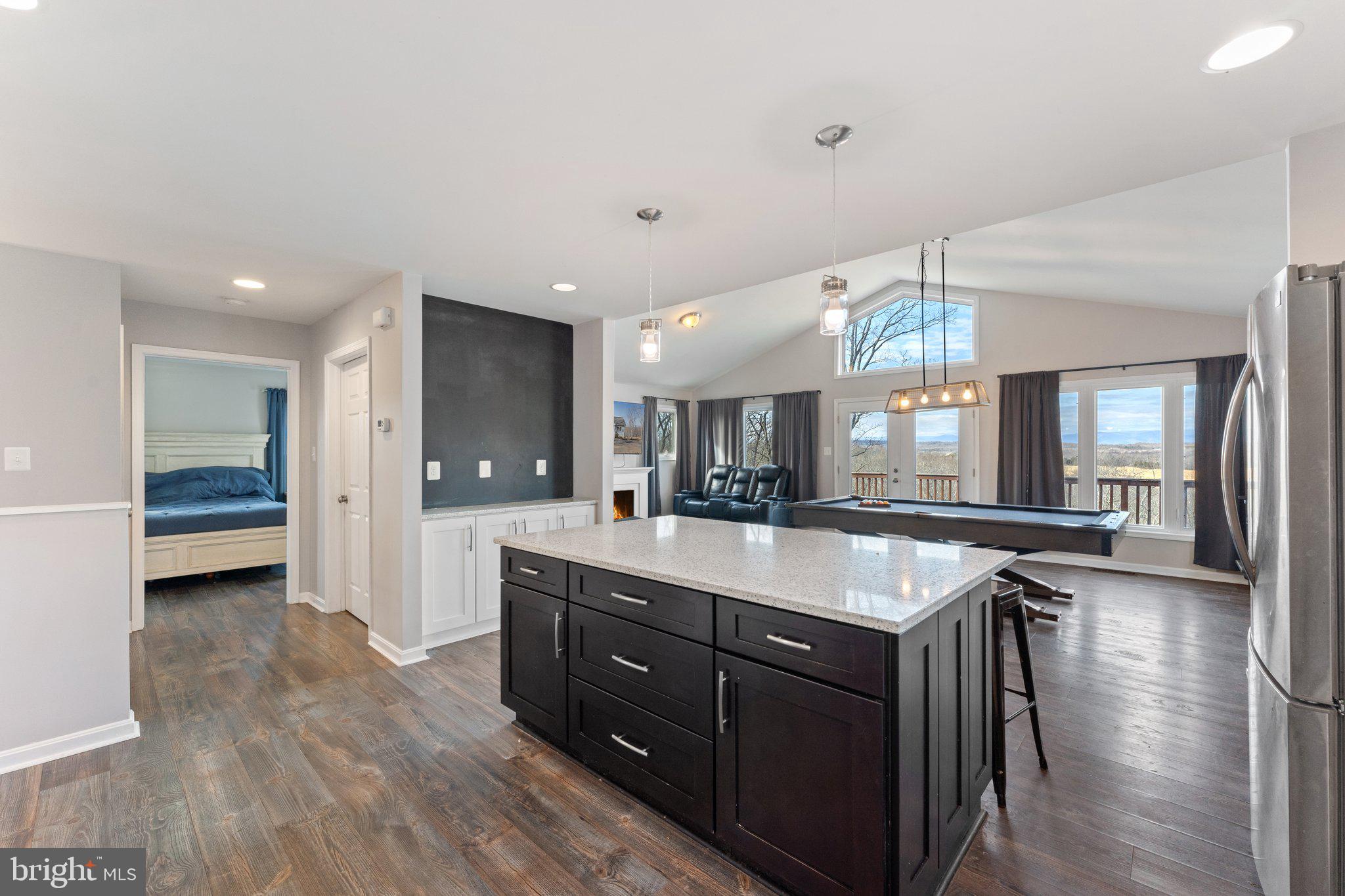 11652 Alum Springs Road Rixeyville, VA 22737 - Photo 26 of 64 a kitchen with stainless steel appliances granite countertop a sink a stove and a wooden floors