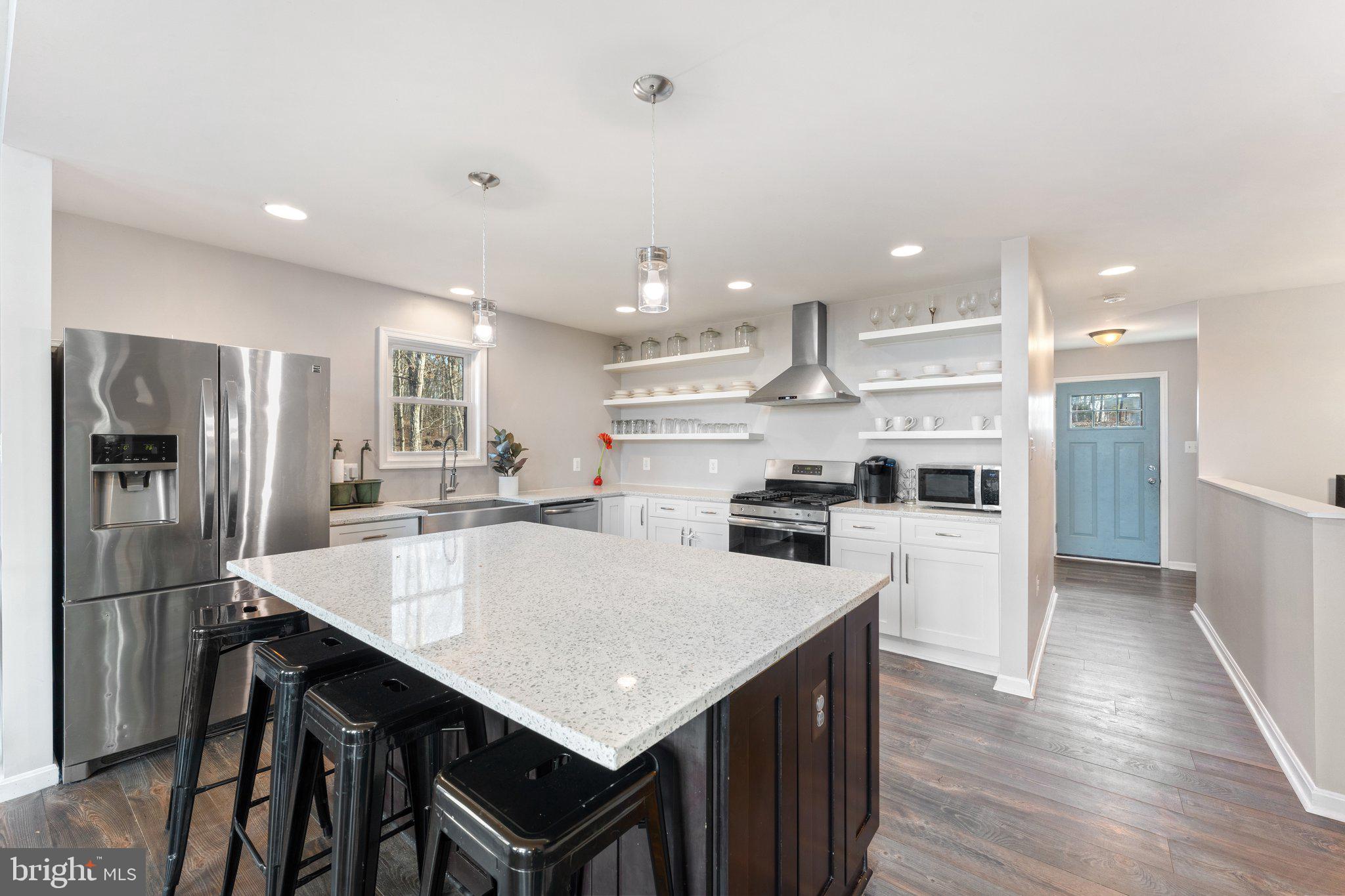 11652 Alum Springs Road Rixeyville, VA 22737 - Photo 27 of 64 a kitchen with stainless steel appliances a table and chairs in it