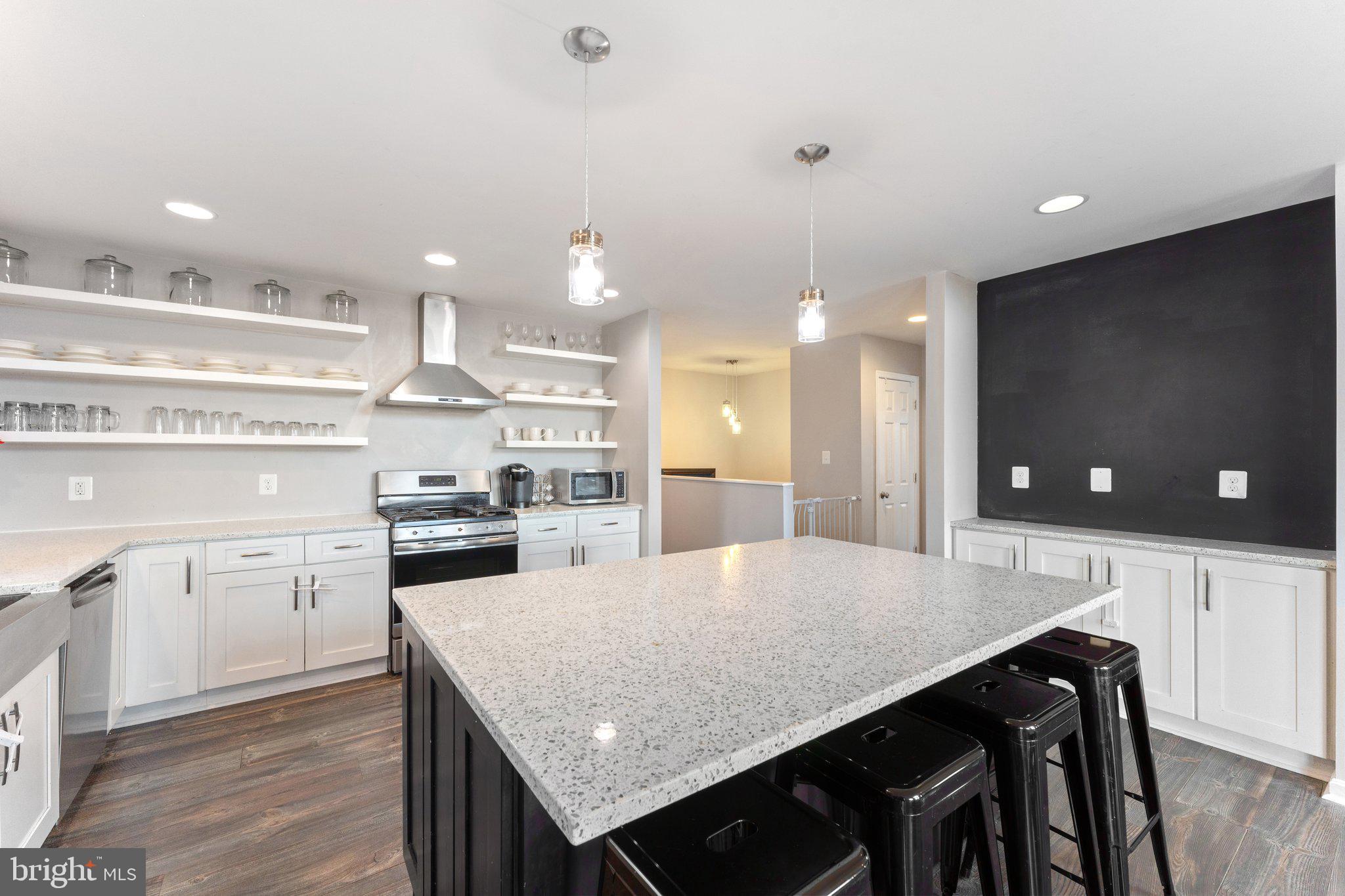 11652 Alum Springs Road Rixeyville, VA 22737 - Photo 28 of 64 a kitchen with stainless steel appliances kitchen island granite countertop a sink a stove a dining table and chairs