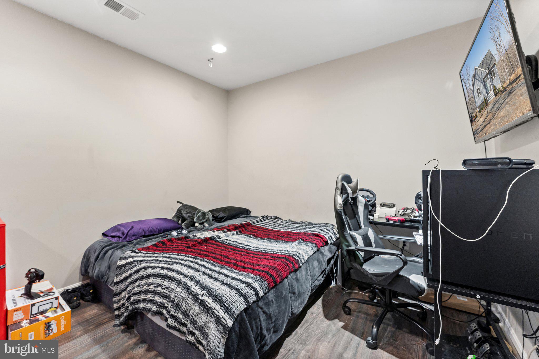 11652 Alum Springs Road Rixeyville, VA 22737 - Photo 43 of 64 a bedroom with a bed a dresser and chair
