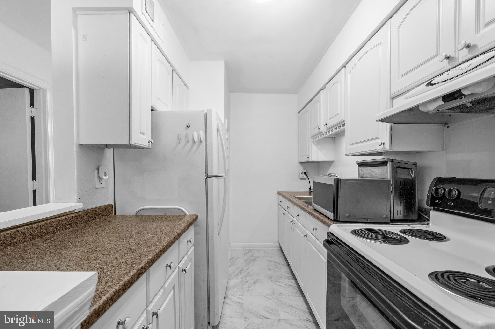 5913 Prince James Drive, Unit J Springfield, VA 22152 - Photo 8 of 33 a kitchen with stainless steel appliances granite countertop a sink stove and refrigerator