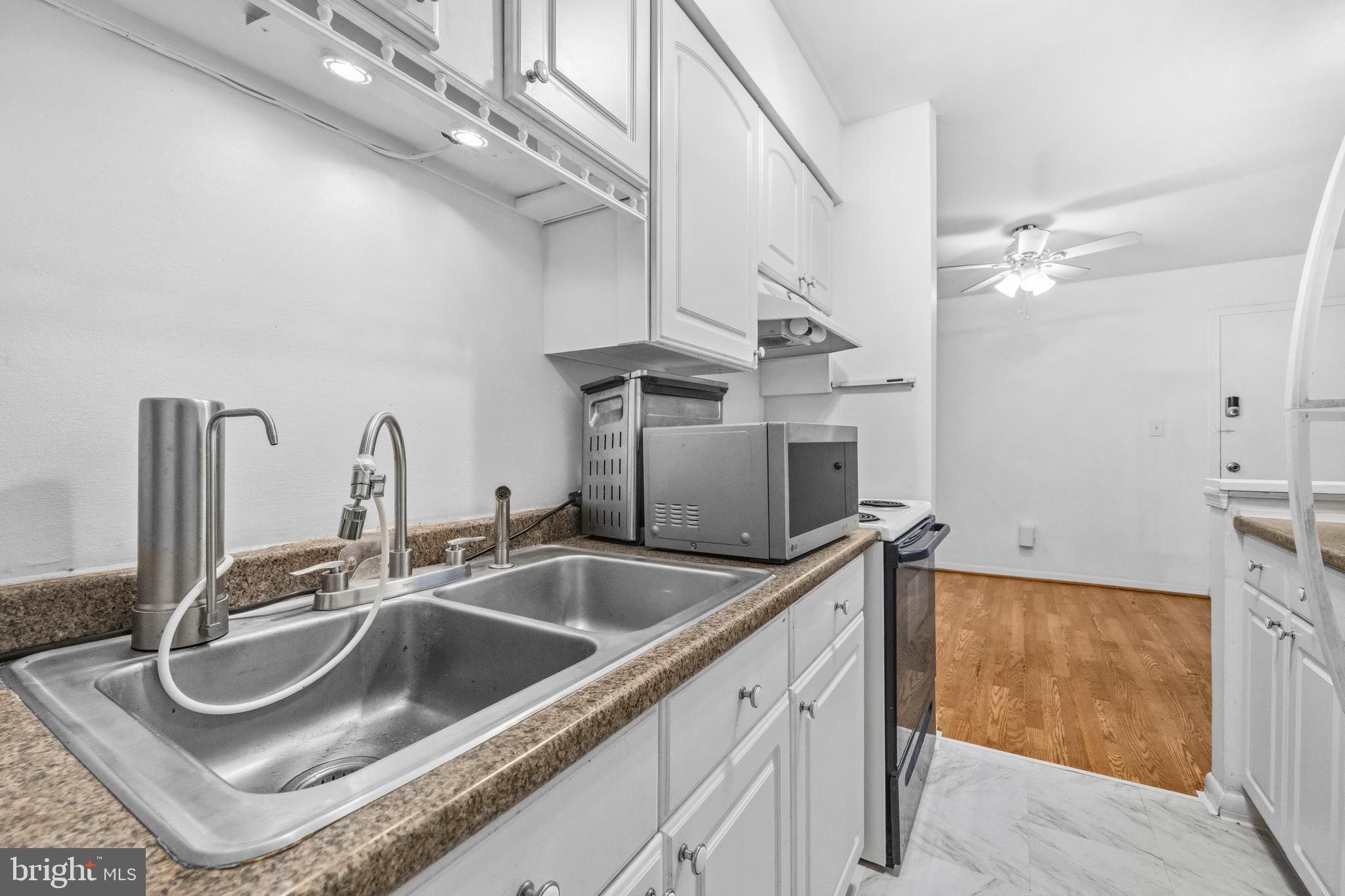 5913 Prince James Drive, Unit J Springfield, VA 22152 - Photo 10 of 33 a kitchen with a sink and a refrigerator