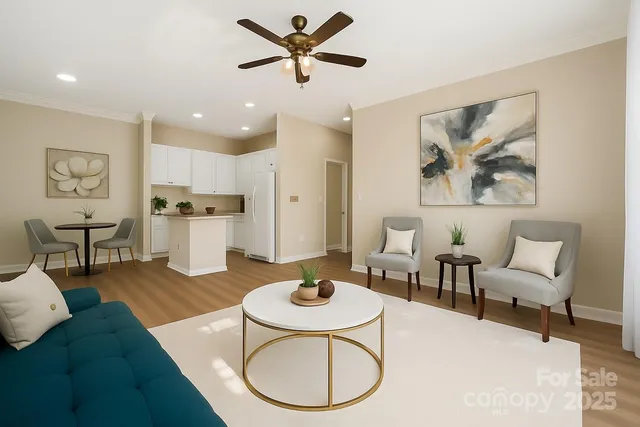a living room with furniture and kitchen view