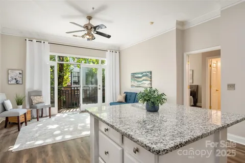a view of living room with granite countertop kitchen island furniture and a chandelier