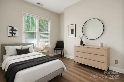 a bedroom with a bed and a potted plant