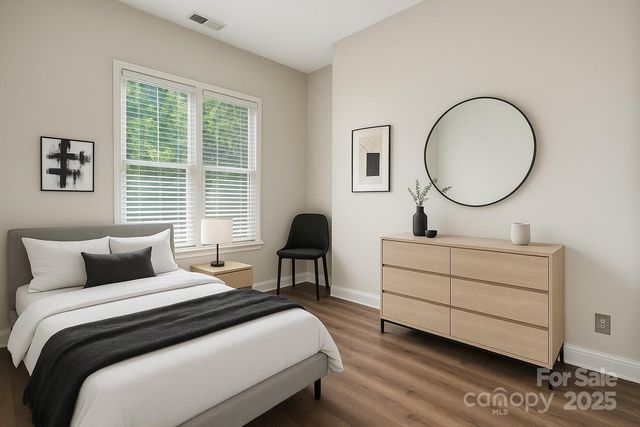 a bedroom with a bed and a potted plant