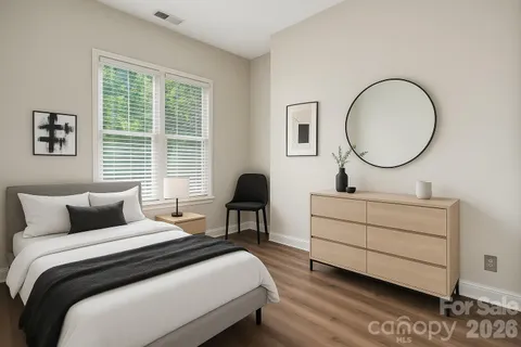 a bedroom with a bed and a potted plant