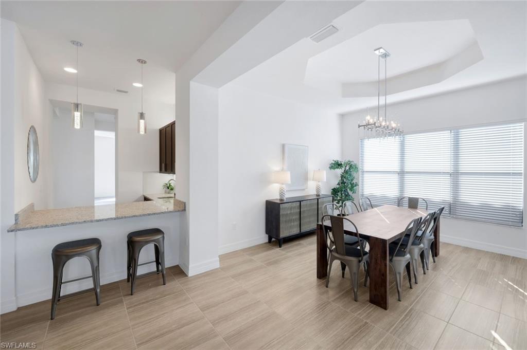 4549 Azalea Drive Naples, FL 34119 - Photo 17 of 49 a view of a a dining room with furniture window and wooden floor