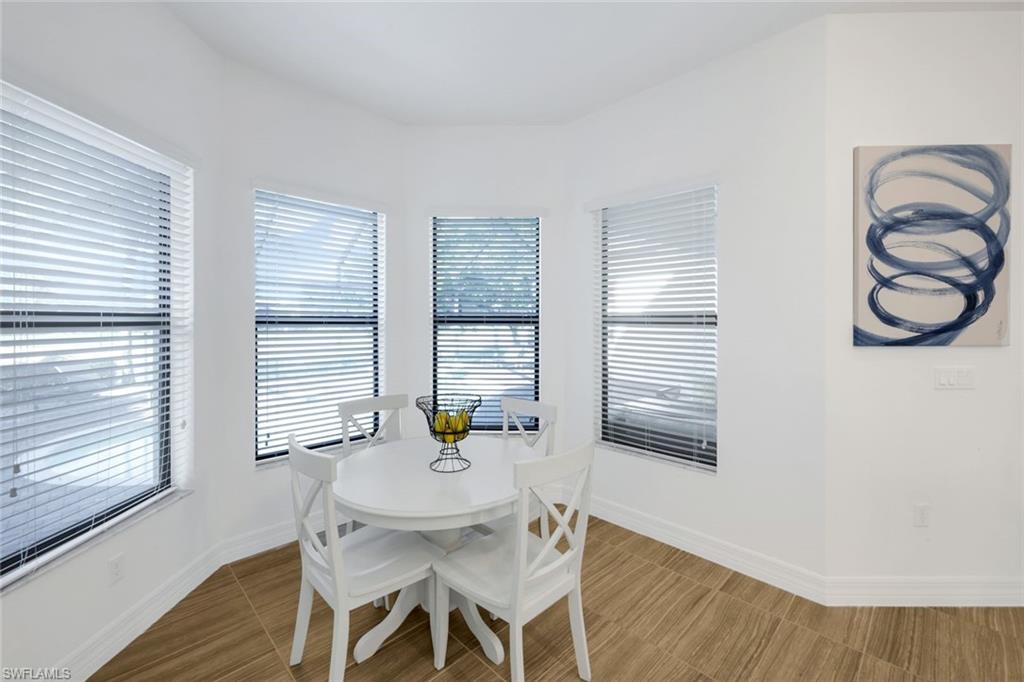 4549 Azalea Drive Naples, FL 34119 - Photo 19 of 49 a view of a dining room with furniture and window