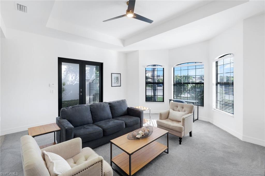 4549 Azalea Drive Naples, FL 34119 - Photo 21 of 49 a living room with furniture and a window