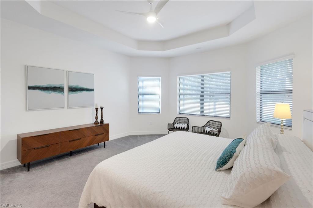 4549 Azalea Drive Naples, FL 34119 - Photo 24 of 49 a bedroom with two beds and a window