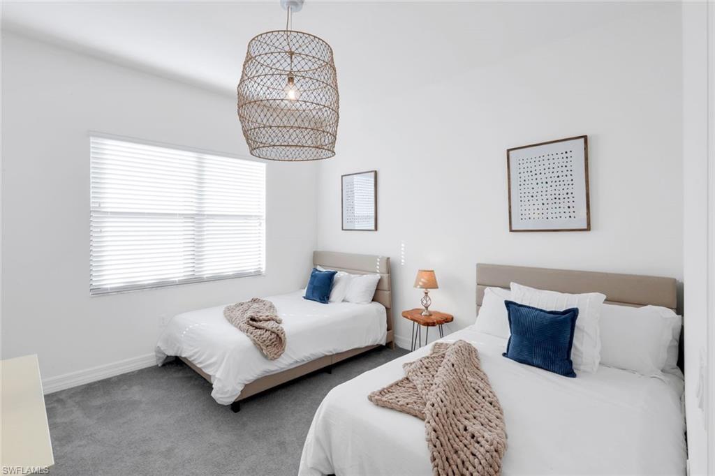 4549 Azalea Drive Naples, FL 34119 - Photo 27 of 49 a bedroom with two beds and a window