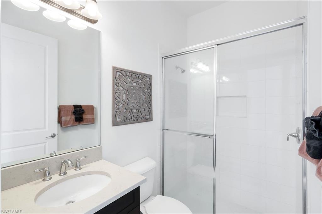4549 Azalea Drive Naples, FL 34119 - Photo 28 of 49 a bathroom with a sink toilet and shower