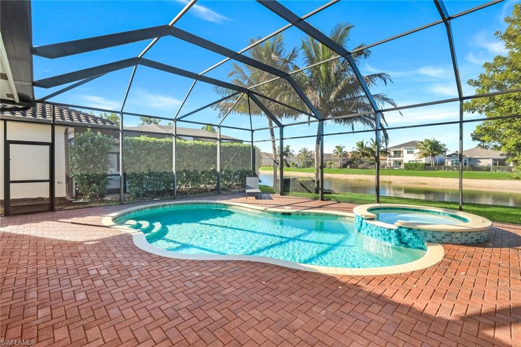 4549 Azalea Drive Naples, FL 34119 - Photo 33 of 49 a view of a swimming pool with a yard