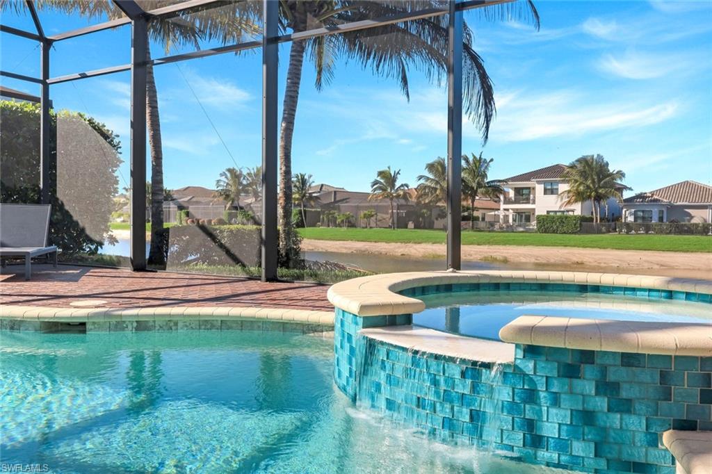 4549 Azalea Drive Naples, FL 34119 - Photo 35 of 49 a view of swimming pool with lawn chairs and a table
