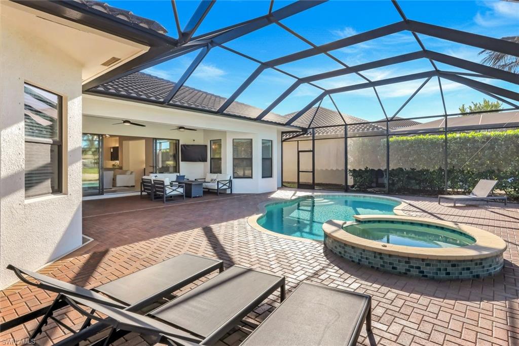4549 Azalea Drive Naples, FL 34119 - Photo 36 of 49 a view of a patio with swimming pool table and chairs