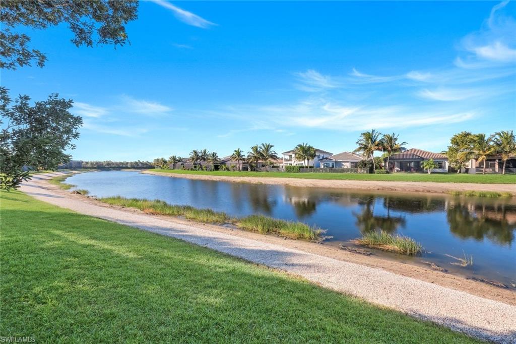 4549 Azalea Drive Naples, FL 34119 - Photo 41 of 49 a view of a lake with houses in the background