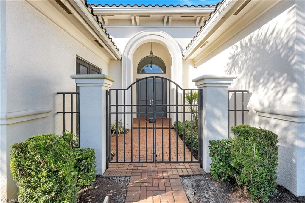 4549 Azalea Drive Naples, FL 34119 - Photo 6 of 49 a view of a entrance gate of a house