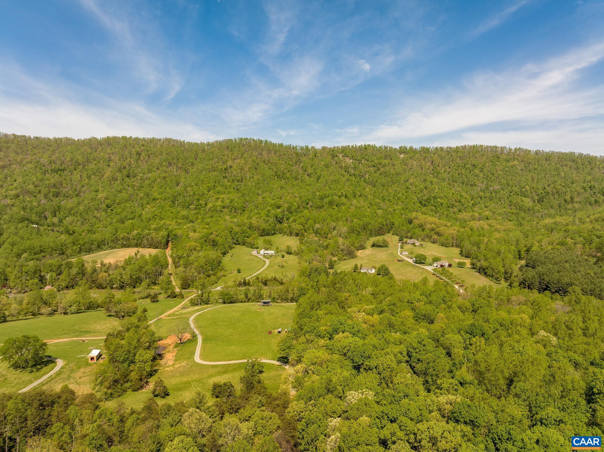 1671 Dudley Mountain Road Charlottesville, VA 22903 - Photo 42 of 60 a view of a lake with mountains in the background