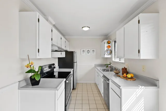 a kitchen with stainless steel appliances granite countertop a sink a stove and a refrigerator