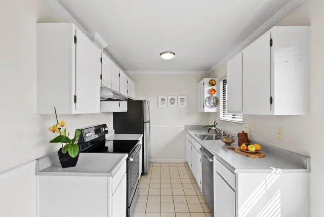 a kitchen with stainless steel appliances granite countertop a sink a stove and a refrigerator