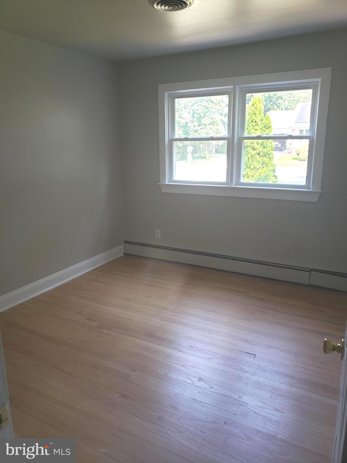 220 Franklin Road Glassboro, NJ 08028 - Photo 22 of 40 an empty room with wooden floor and windows