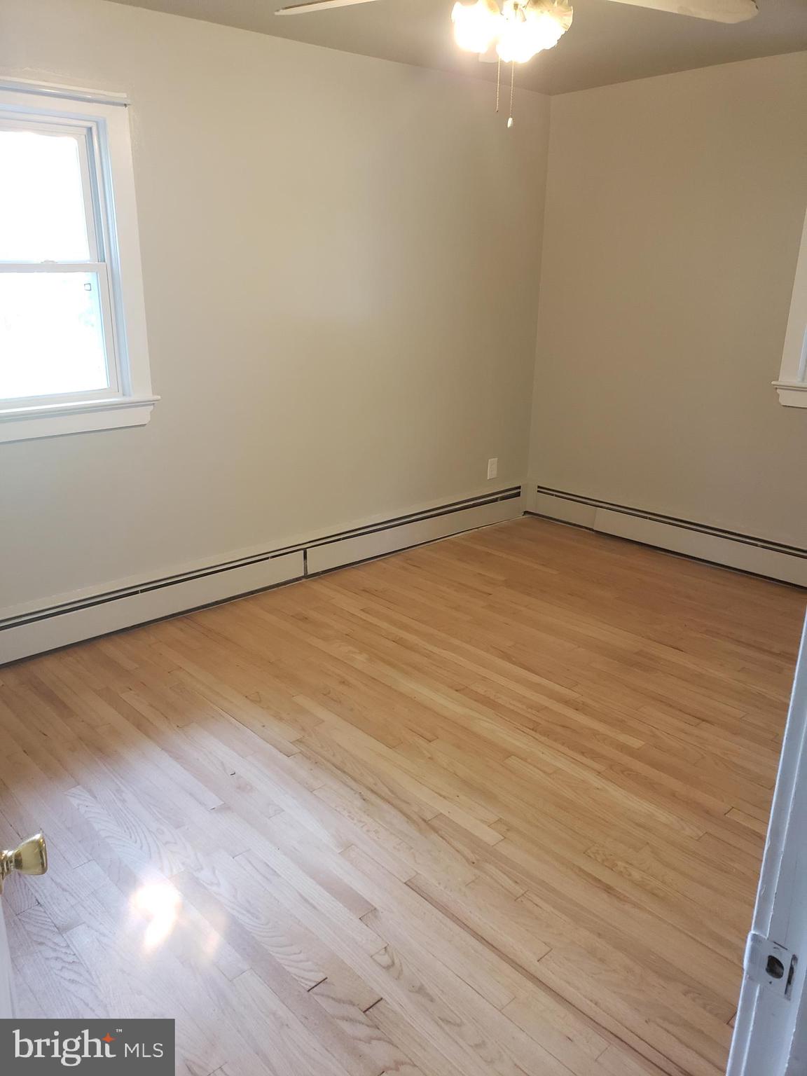 220 Franklin Road Glassboro, NJ 08028 - Photo 24 of 40 a view of an empty room with wooden floor and a window