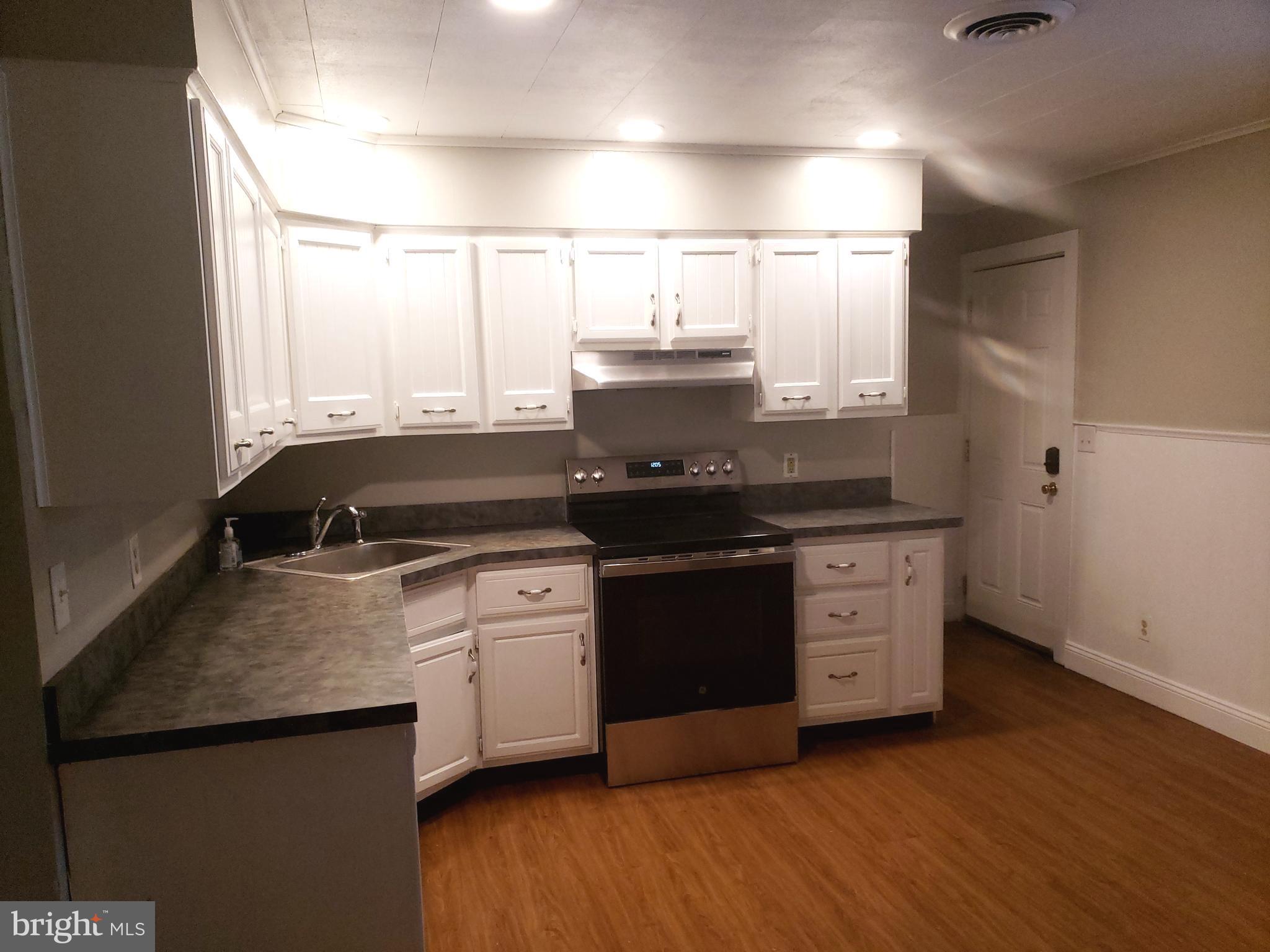 220 Franklin Road Glassboro, NJ 08028 - Photo 7 of 40 a kitchen with a stove and a microwave