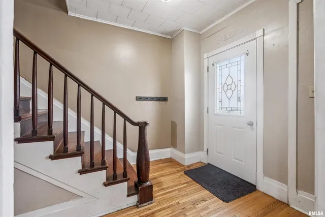 a view of entryway with wooden floor and stairs