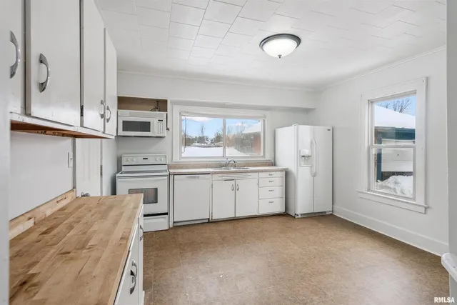 a kitchen with refrigerator and cabinets