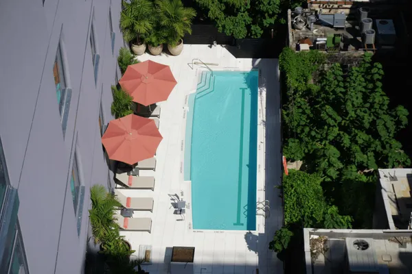 an aerial view of a house with a yard and a fountain