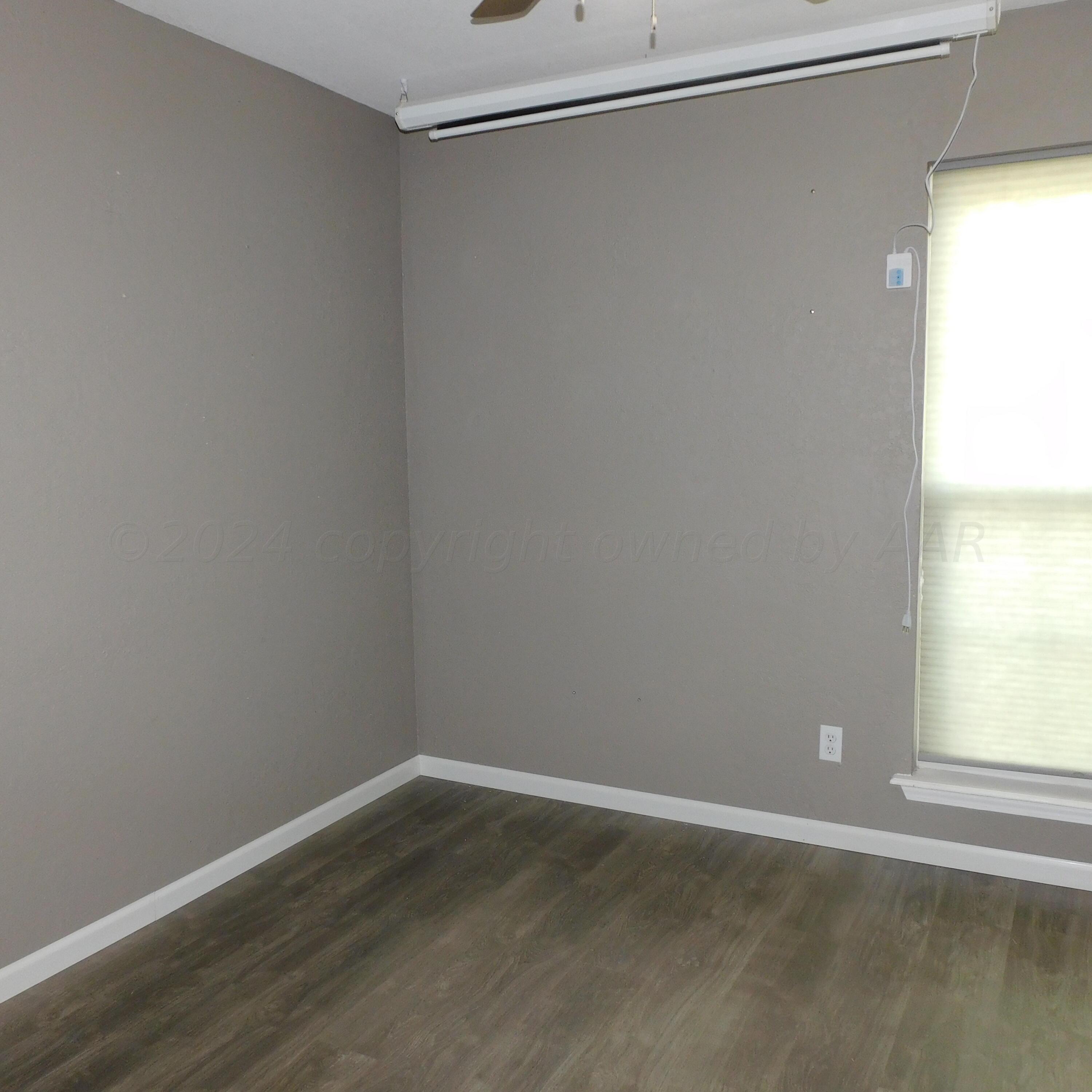 2201 Troveta Drive Amarillo, TX 79110 - Photo 16 of 33 a view of a small space with wooden floor and a window