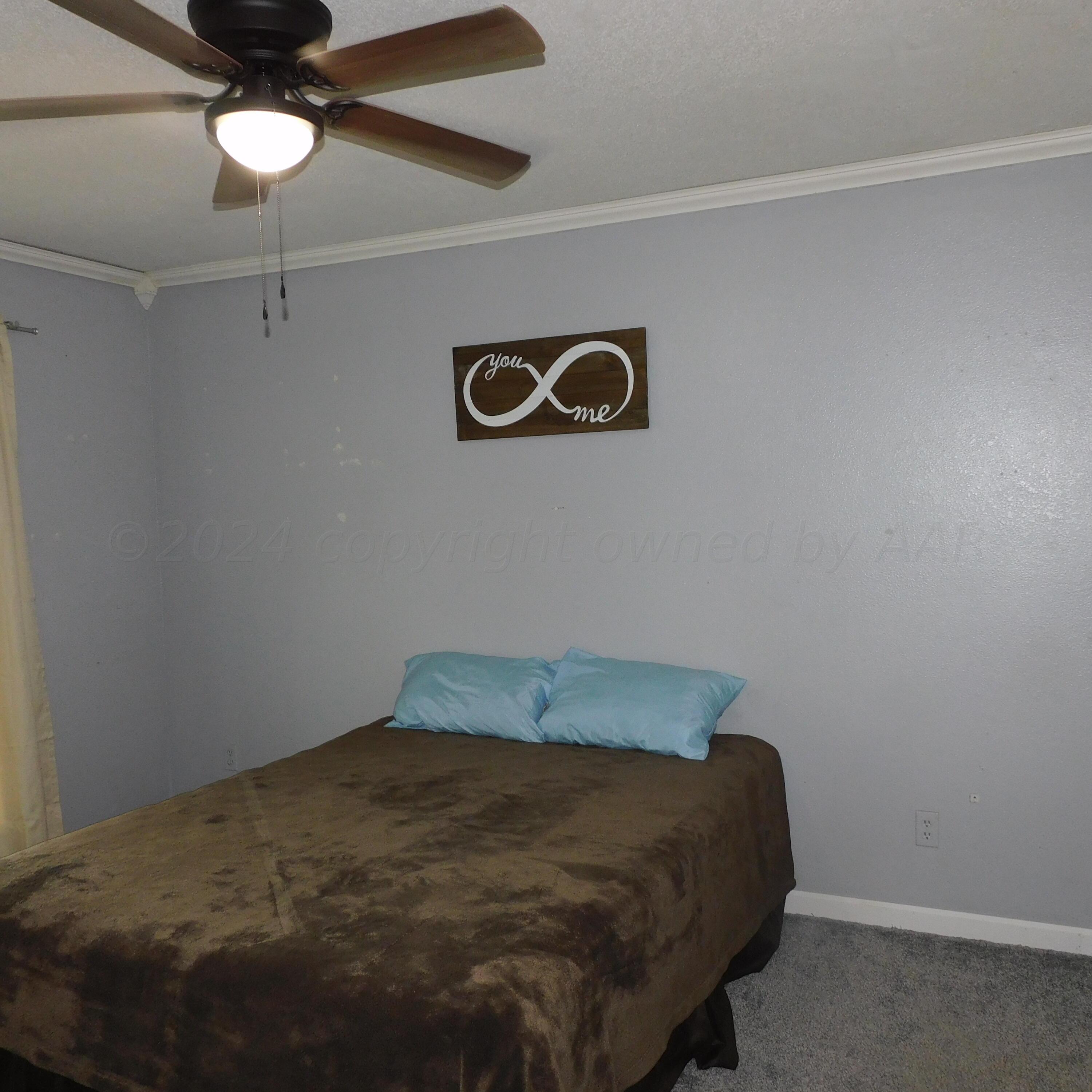 2201 Troveta Drive Amarillo, TX 79110 - Photo 19 of 33 a room with a bed and a chandelier