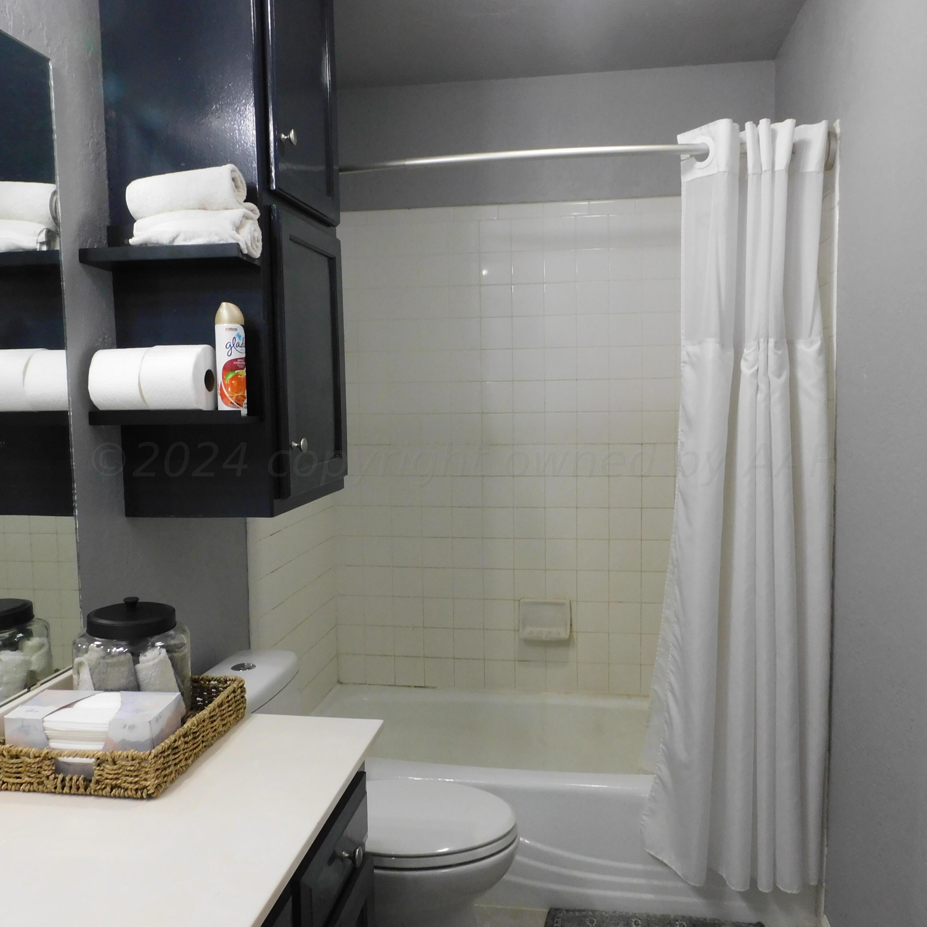 2201 Troveta Drive Amarillo, TX 79110 - Photo 20 of 33 a bathroom with a sink toilet and shower