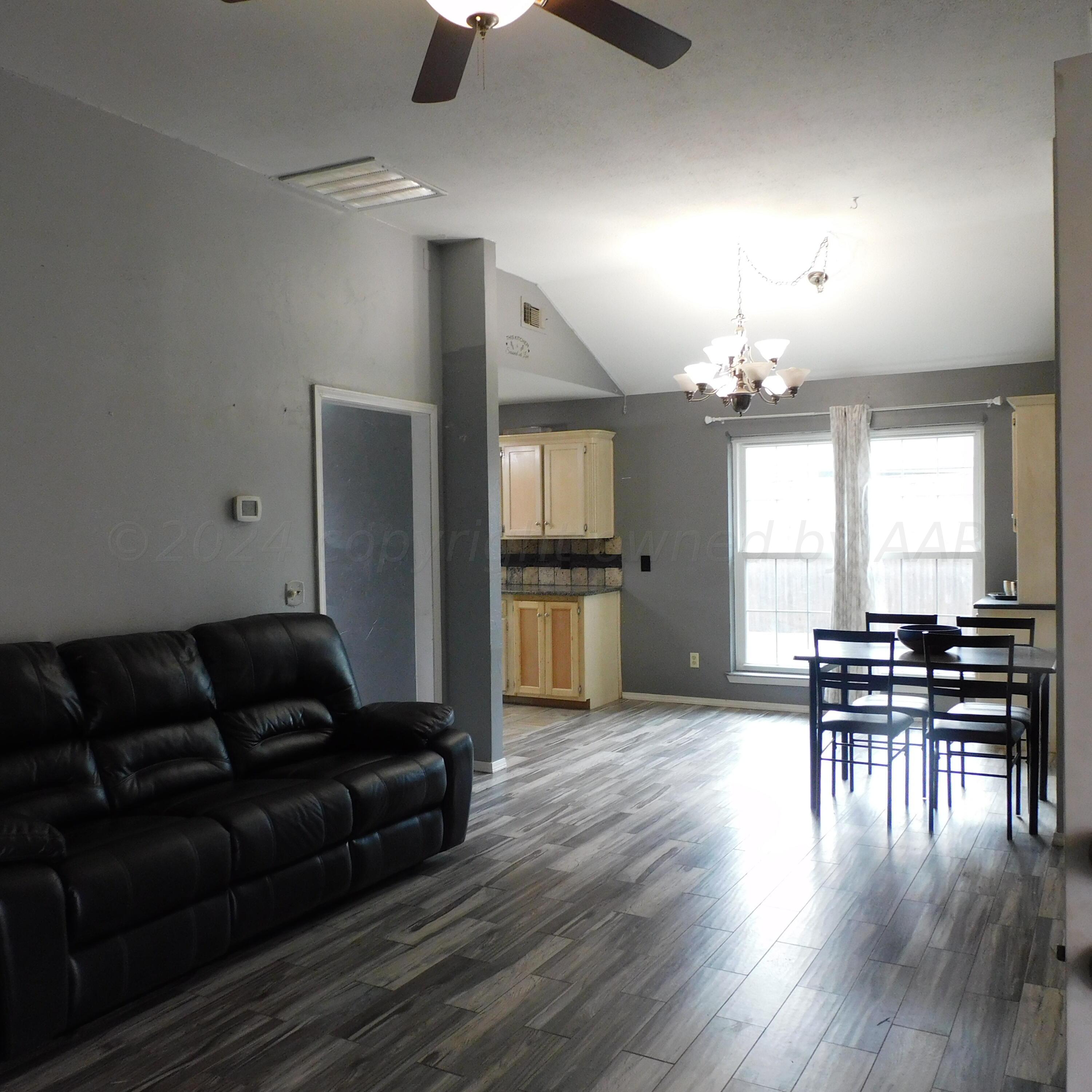 2201 Troveta Drive Amarillo, TX 79110 - Photo 23 of 33 a living room with furniture dining table and wooden floor