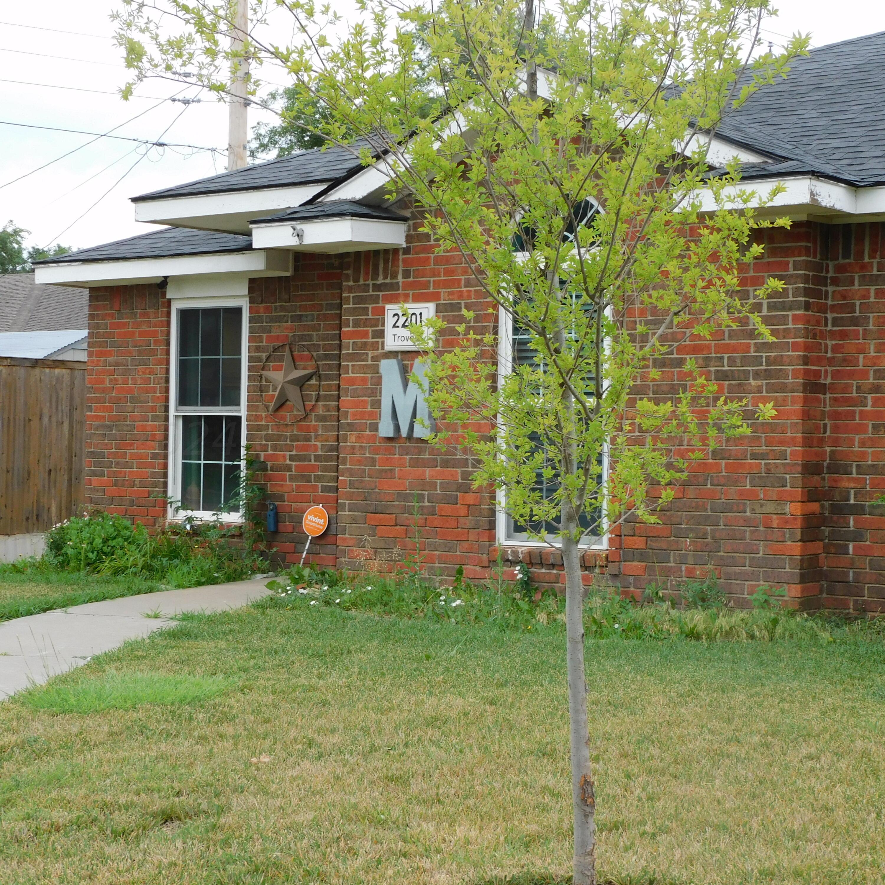 2201 Troveta Drive Amarillo, TX 79110 - Photo 3 of 33 a brick house with a yard plants and large tree