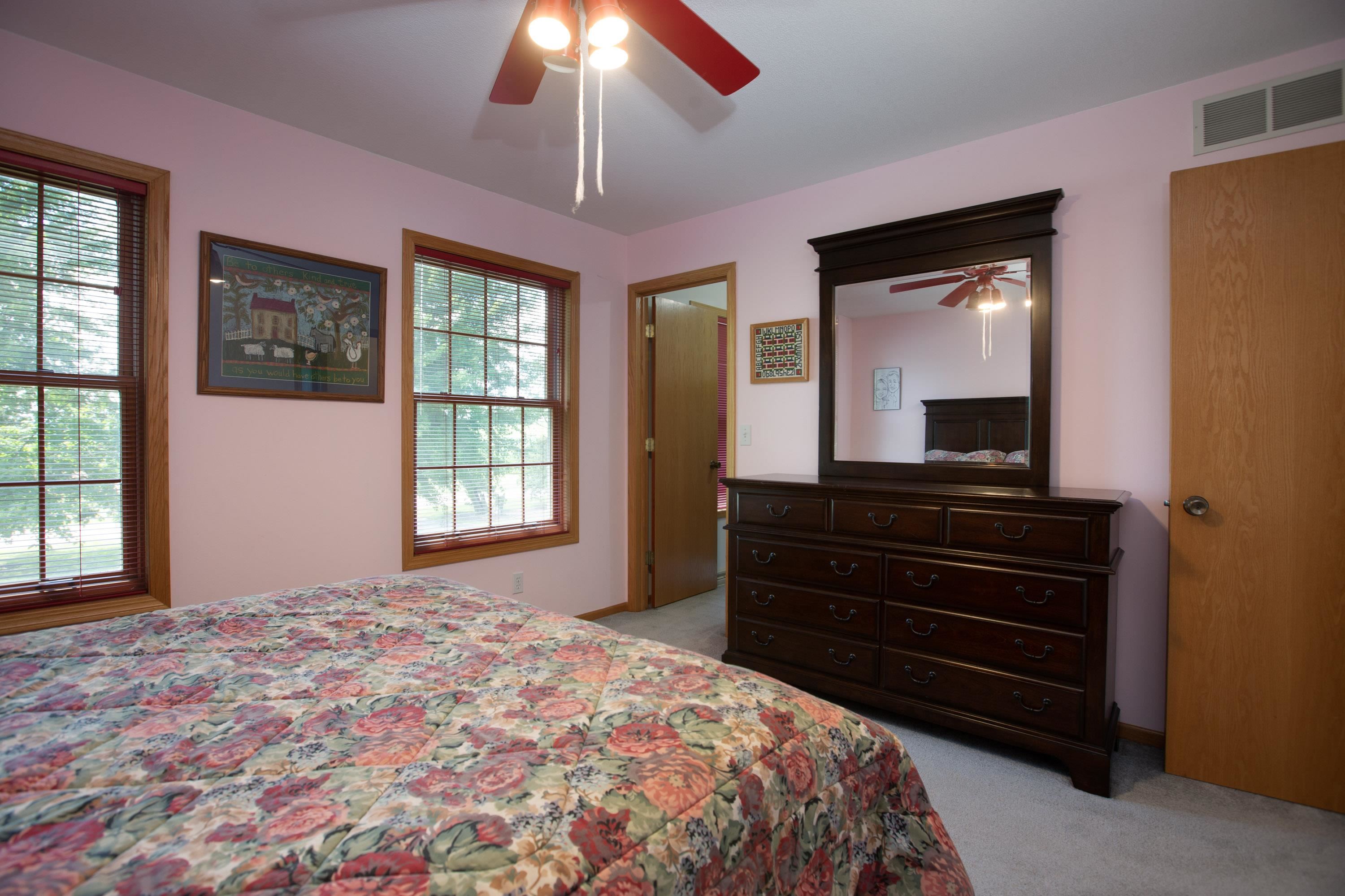 17092 Blackhawk Road Shullsburg, WI 53586 - Photo 26 of 50 a bedroom with a bed and a chandelier