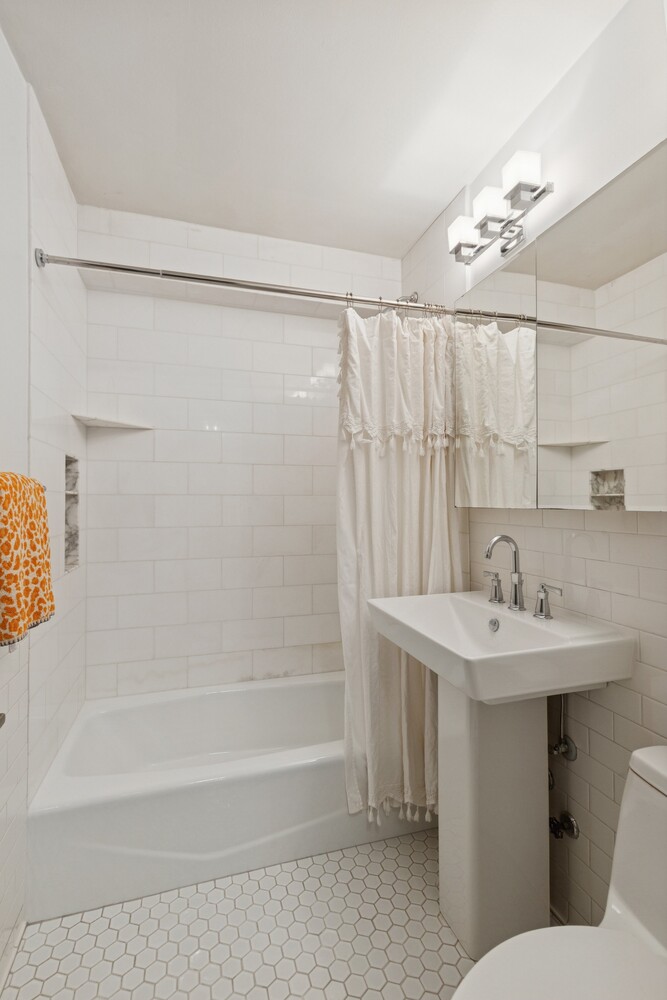 13 West 13th Street, Unit 7FS Manhattan, NY 10011 - Photo 10 of 11 a bathroom with a sink a toilet and shower