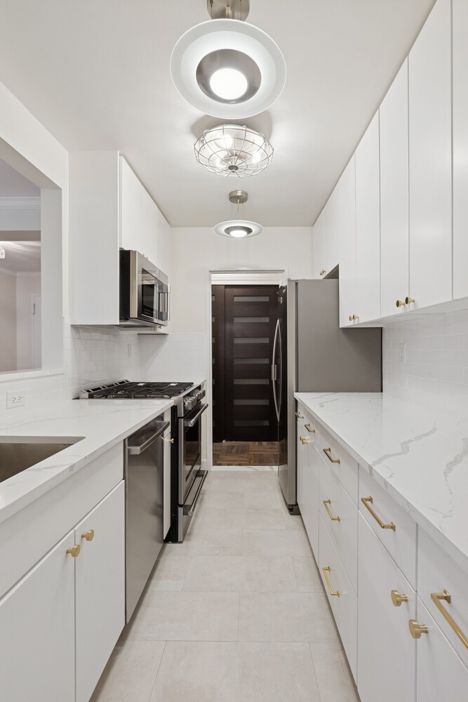 13 West 13th Street, Unit 7FS Manhattan, NY 10011 - Photo 3 of 11 a kitchen with cabinets appliances and a sink