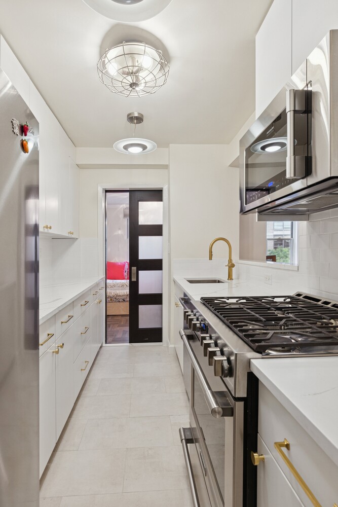 13 West 13th Street, Unit 7FS Manhattan, NY 10011 - Photo 4 of 11 a kitchen with cabinets and appliances