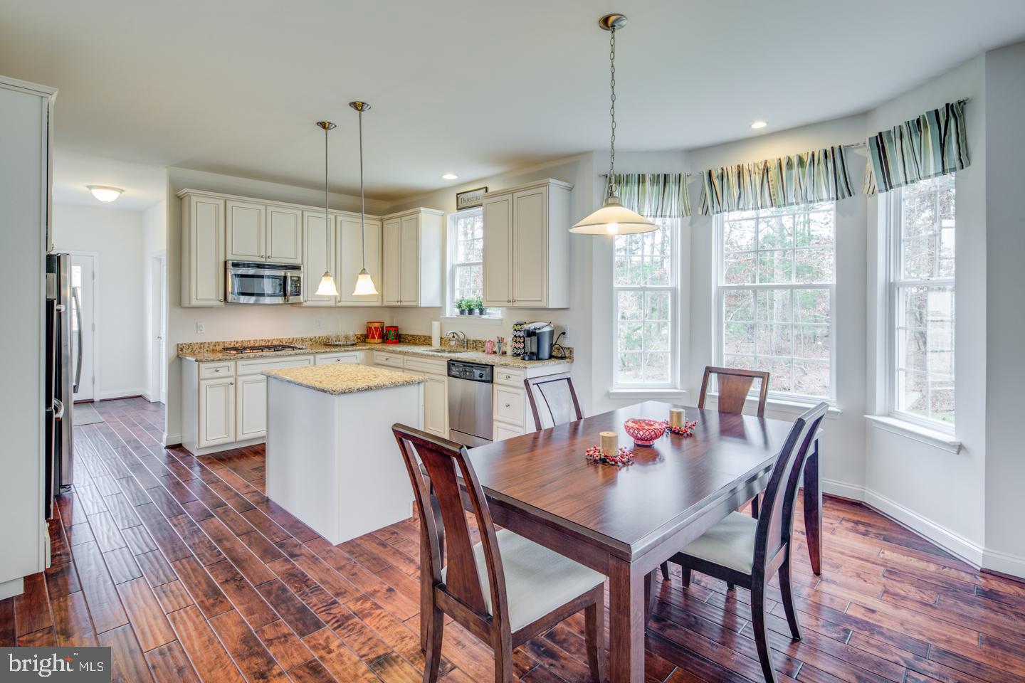20 Champlain Road Marlton, NJ 08053 - Photo 11 of 15 a view of a dining room and livingroom with furniture wooden floor a chandelier