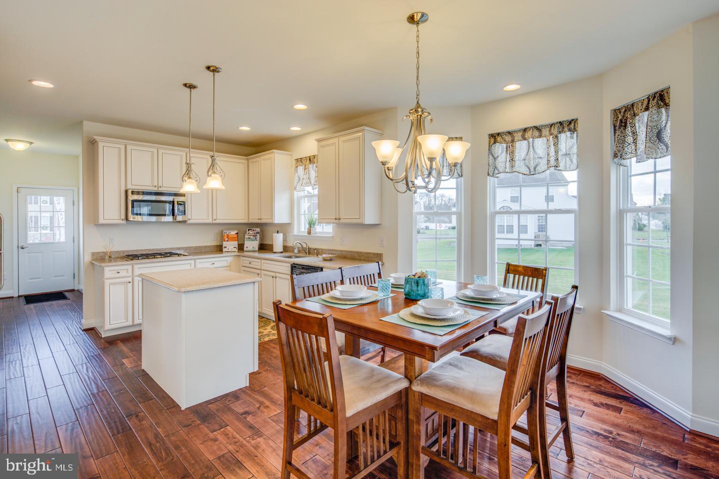 20 Champlain Road Marlton, NJ 08053 - Photo 14 of 15 a dining room with stainless steel appliances kitchen island granite countertop a table chairs and a refrigerator