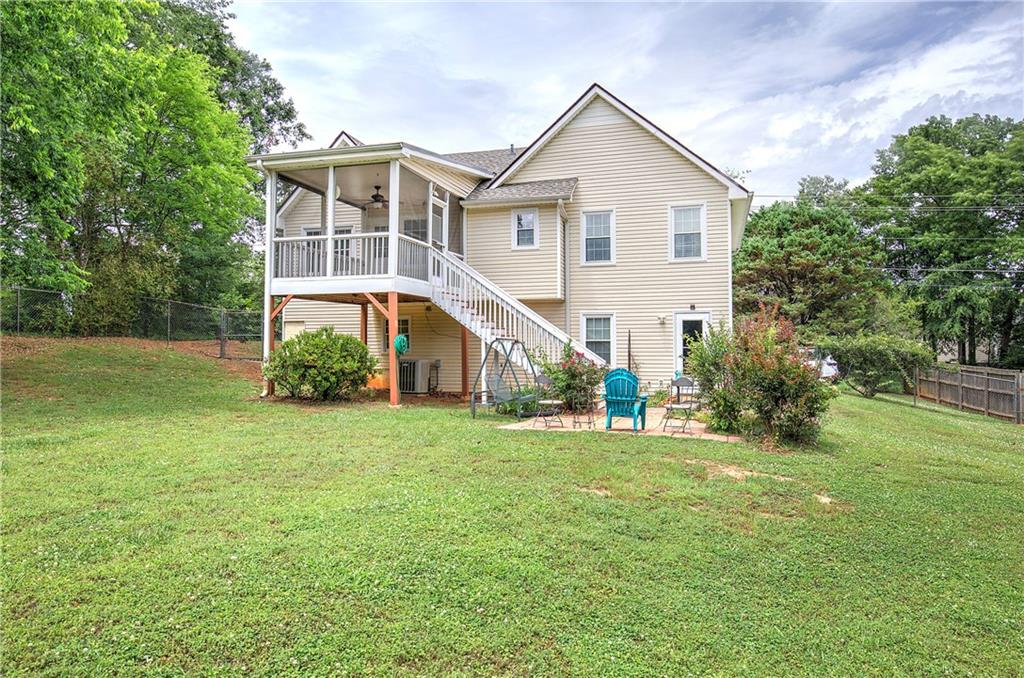 218 Gilreath Road Southeast Cartersville, GA 30121 - Photo 25 of 27 a view of a big house with a big yard and large trees