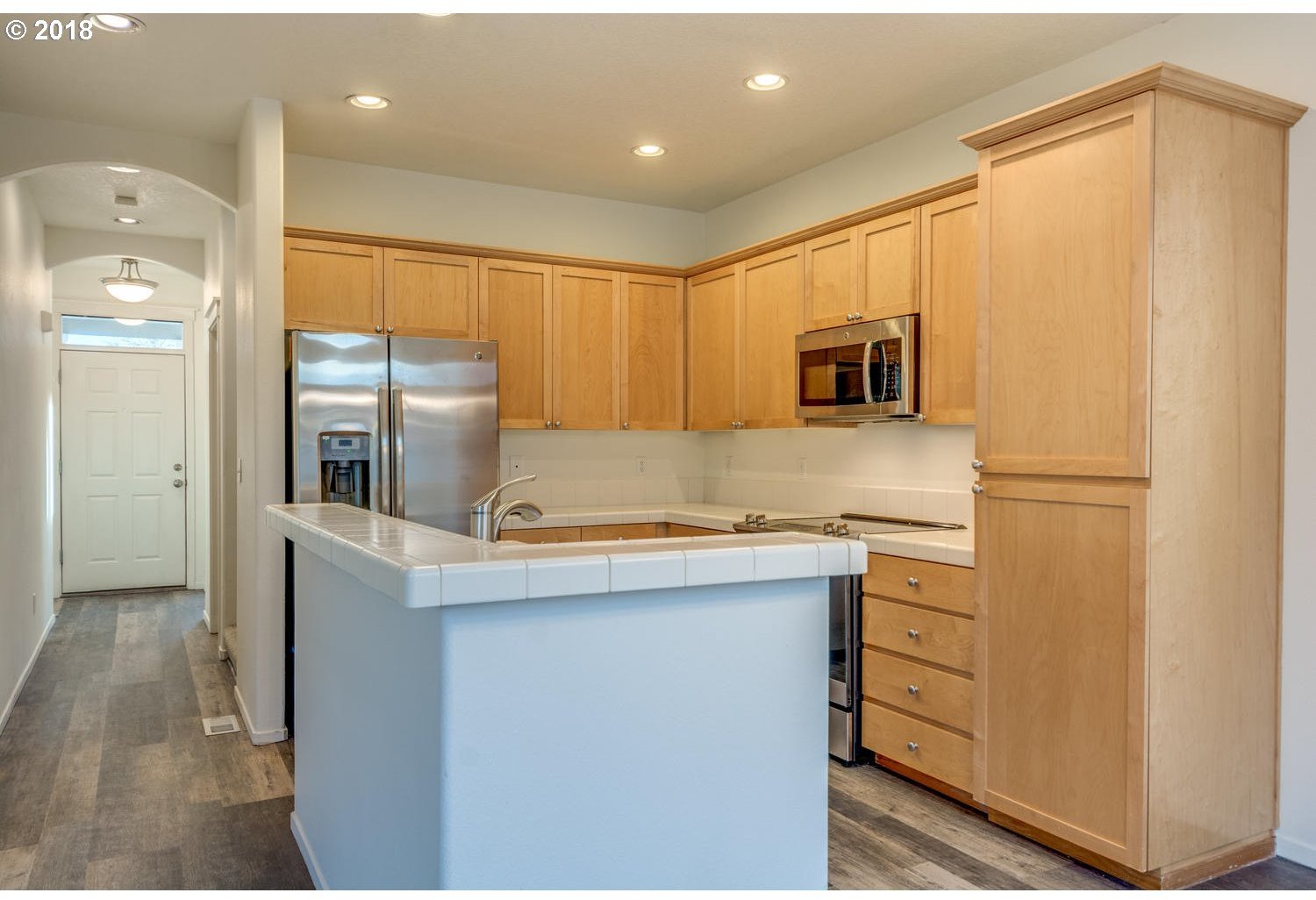 20591 Southwest Ravenswood Street Beaverton, OR 97078 - Photo 15 of 31 a kitchen with stainless steel appliances granite countertop a refrigerator and a stove