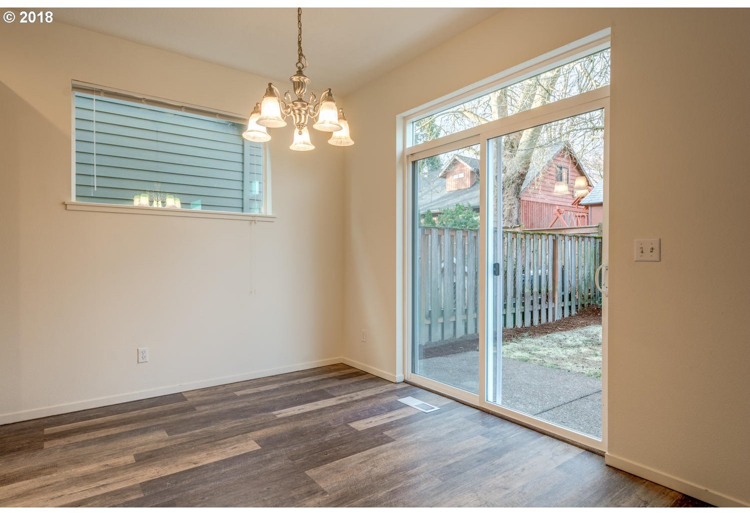 20591 Southwest Ravenswood Street Beaverton, OR 97078 - Photo 17 of 31 a view of a livingroom with wooden floor and a large window