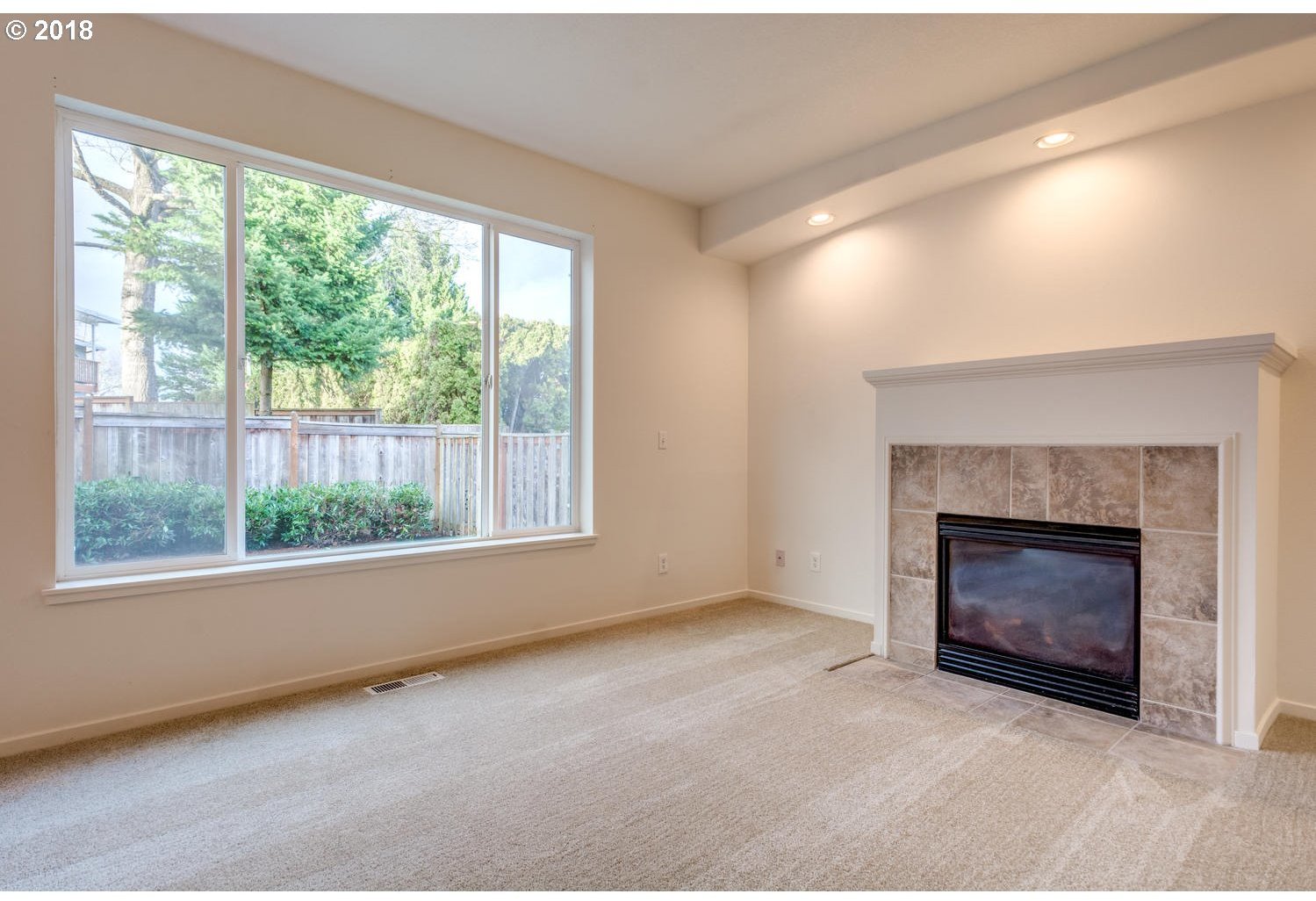 20591 Southwest Ravenswood Street Beaverton, OR 97078 - Photo 18 of 31 a view of an empty room with a fireplace and window