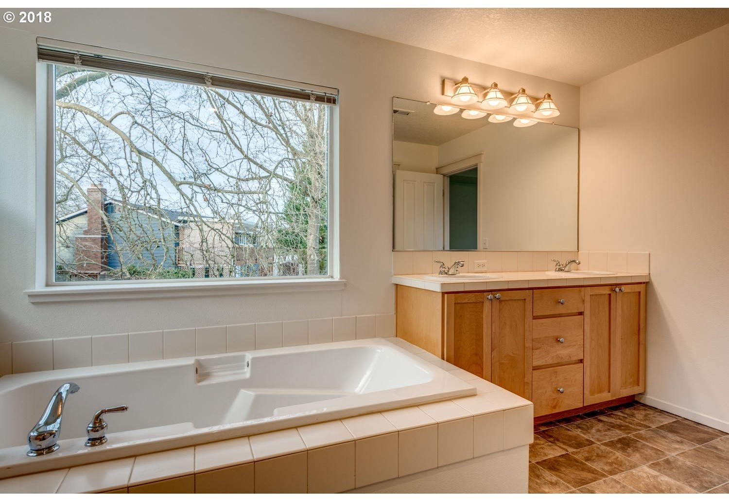 20591 Southwest Ravenswood Street Beaverton, OR 97078 - Photo 25 of 31 a bathroom with a tub sink and mirror