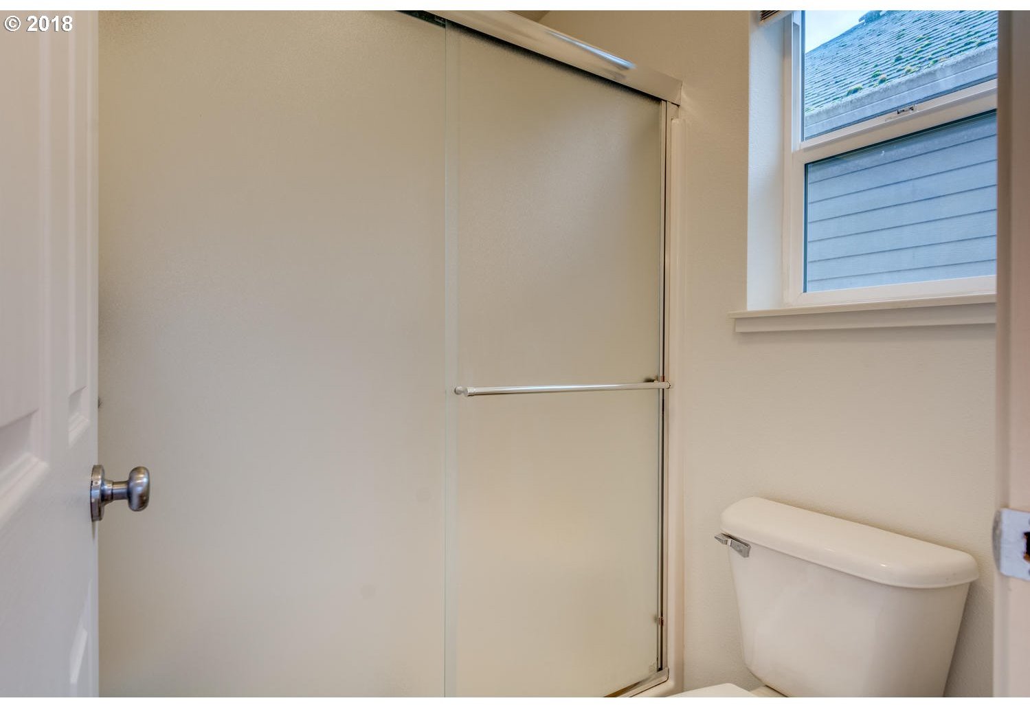 20591 Southwest Ravenswood Street Beaverton, OR 97078 - Photo 26 of 31 a white toilet sitting next to a window