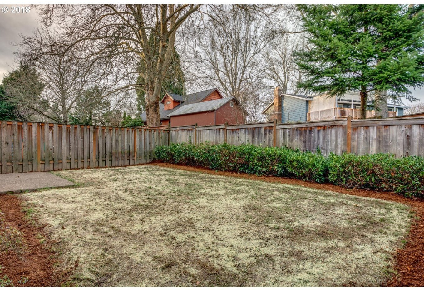 20591 Southwest Ravenswood Street Beaverton, OR 97078 - Photo 31 of 31 a backyard of a house with plants and tree with wooden fence